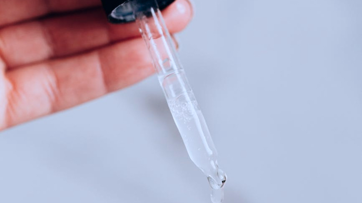 Close up of a pipette of clear liquid.