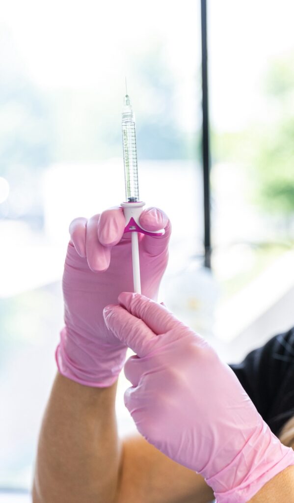 A provider holds a syringe of Lip Fillers near me | Overland Park, KS.